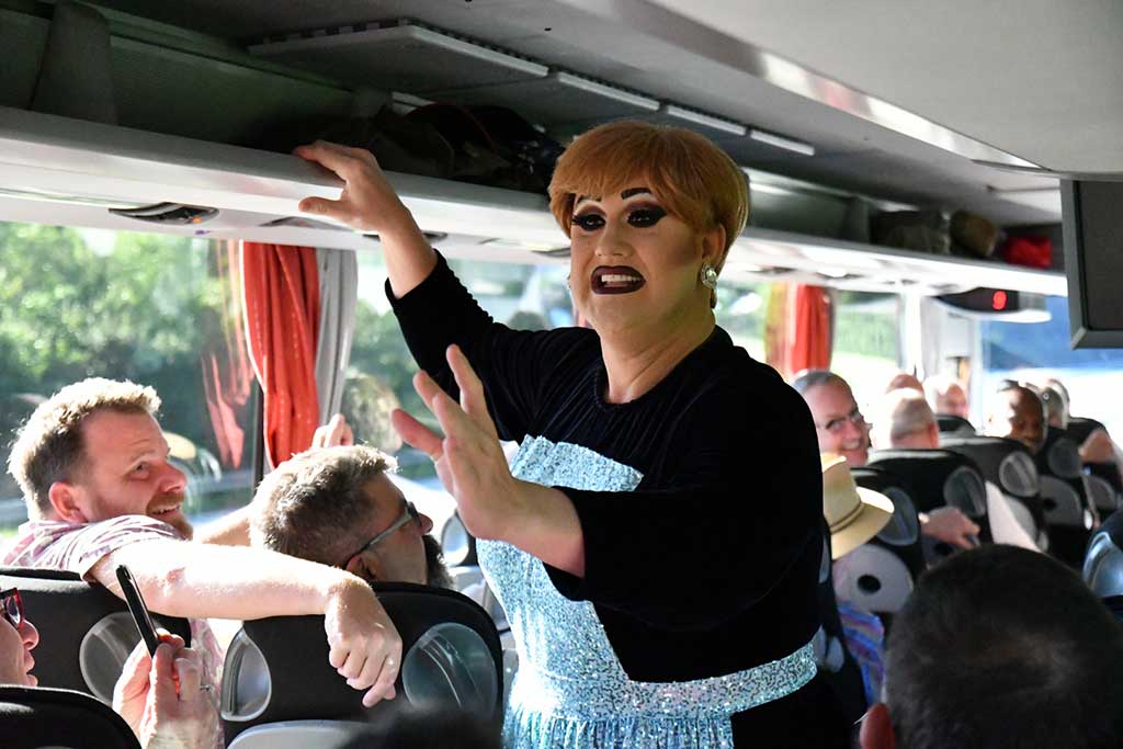 Miss Conception. Leading sing-along en route to Salzberg for the Sound of Music tour Danube Gay Cruises