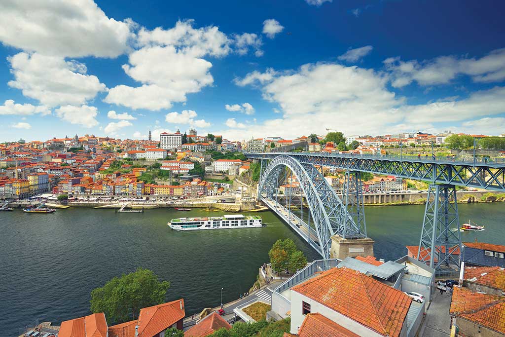 Scenic Azure Passes Under The Dom Luís I Bridge in Porto