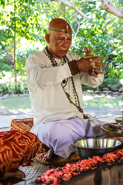 Balinese High Priest Conducting a Fire Purification Ceremony