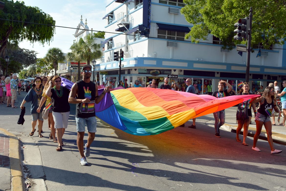 Marchers carry a giant pride flag